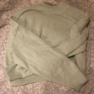 green cowl neck slightly cropped sweater. size M.